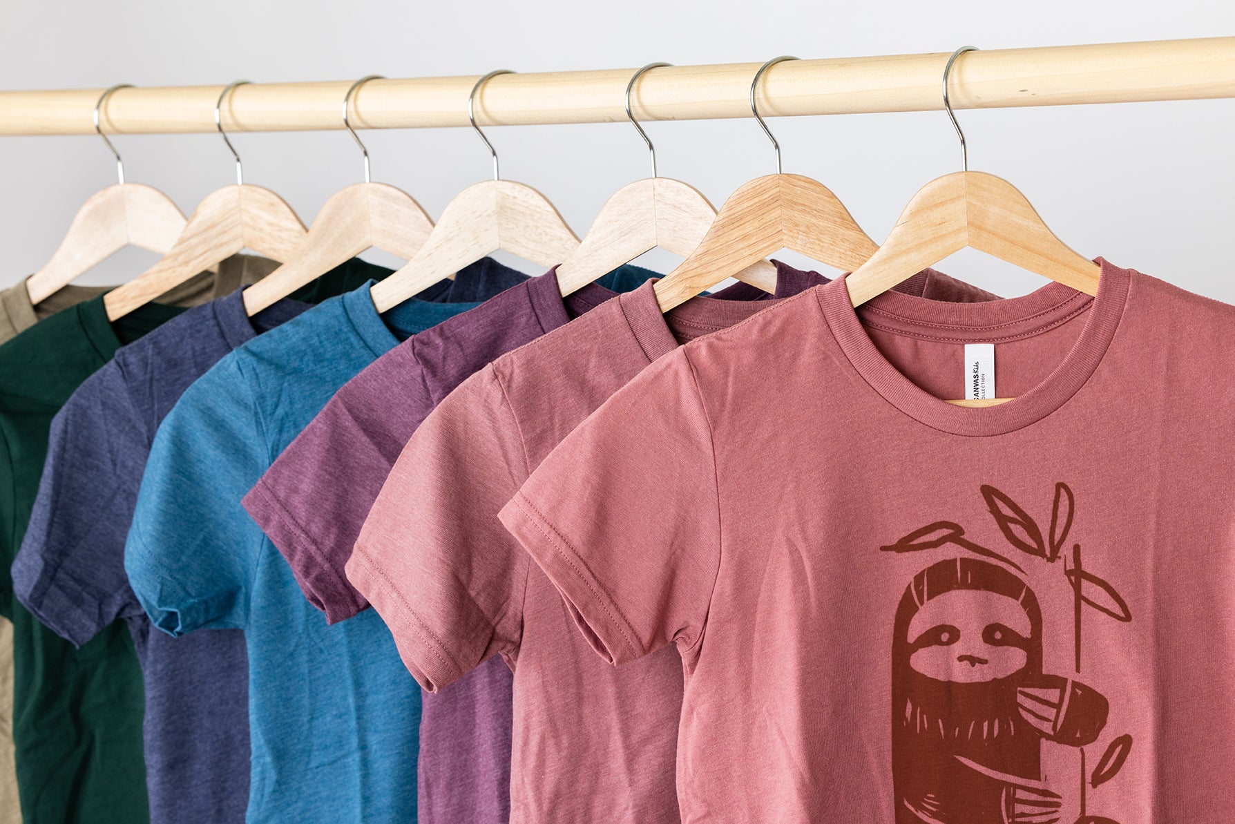 Children's holiday and seasonal t-shirt subscription including sloth graphic..